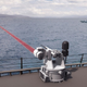Illustration for article titled How to Make a Giant Chain Gun Even Deadlier: Give It a Laser Cannon!